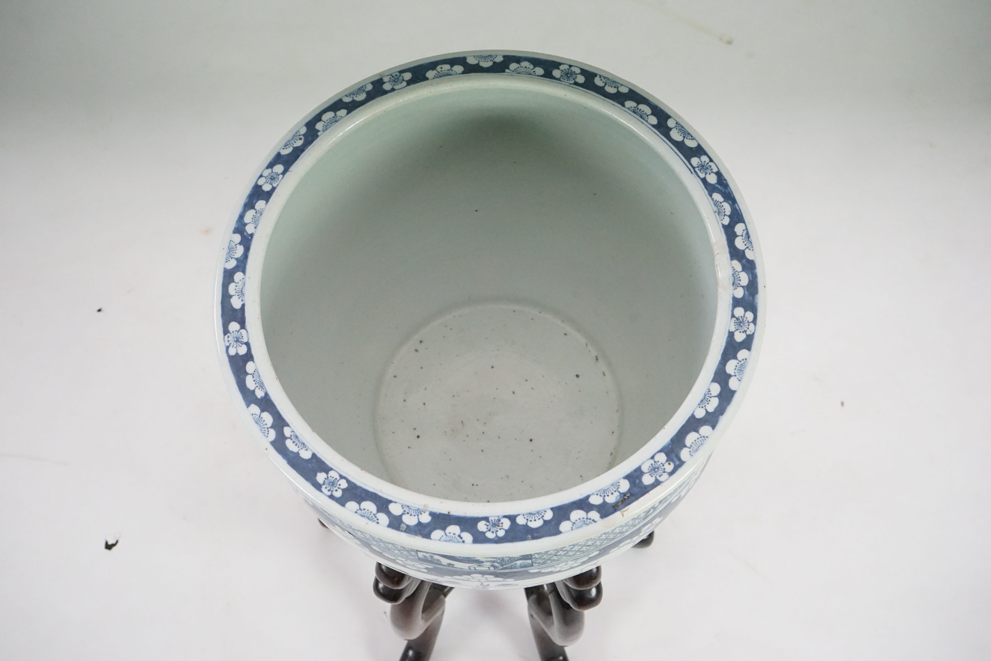 A large Chinese blue and white ‘Hundred Antiques’ jardinere and hongmu stand, late 19th/early 20th century